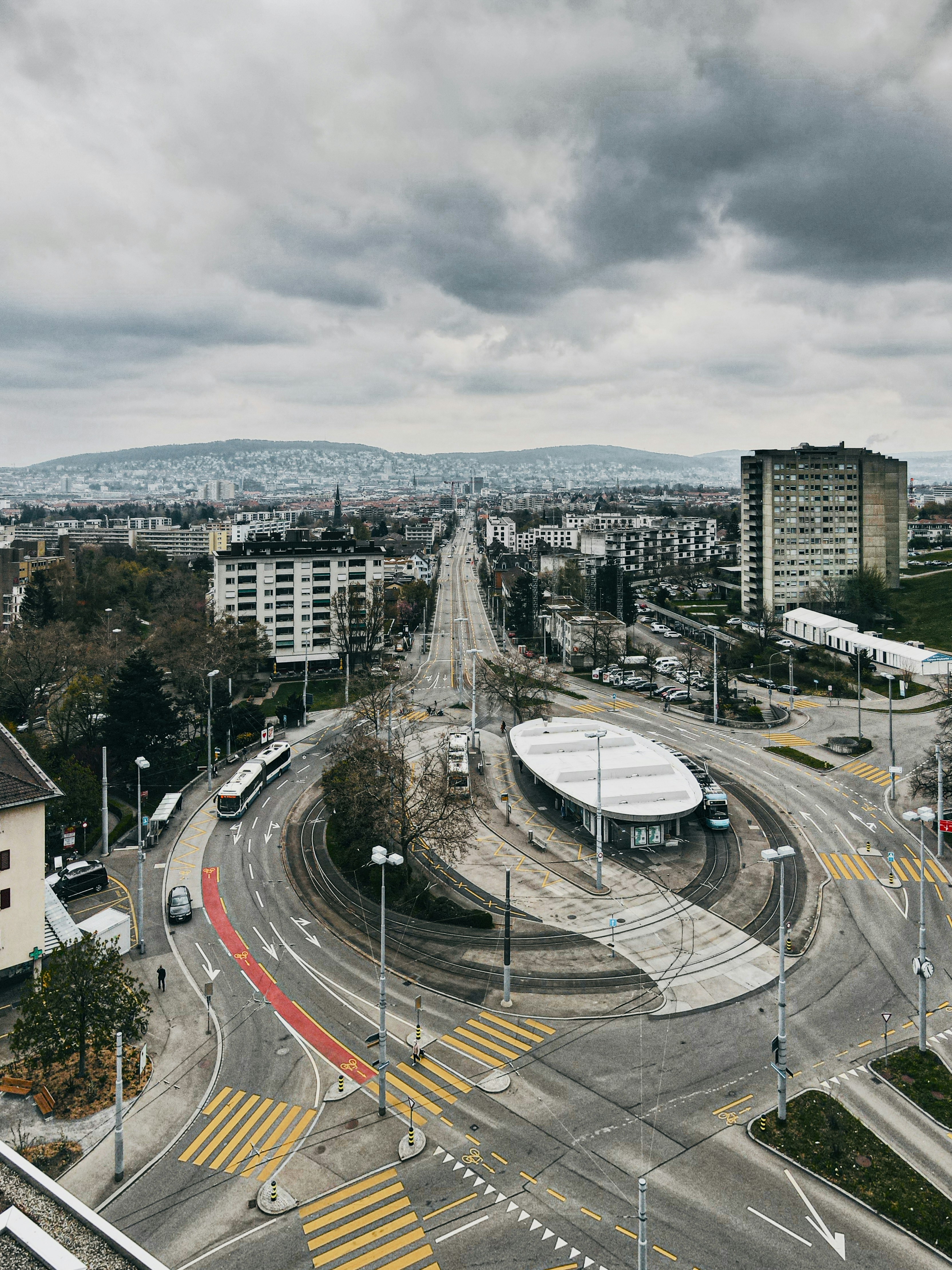 cars on road near city buildings during daytime